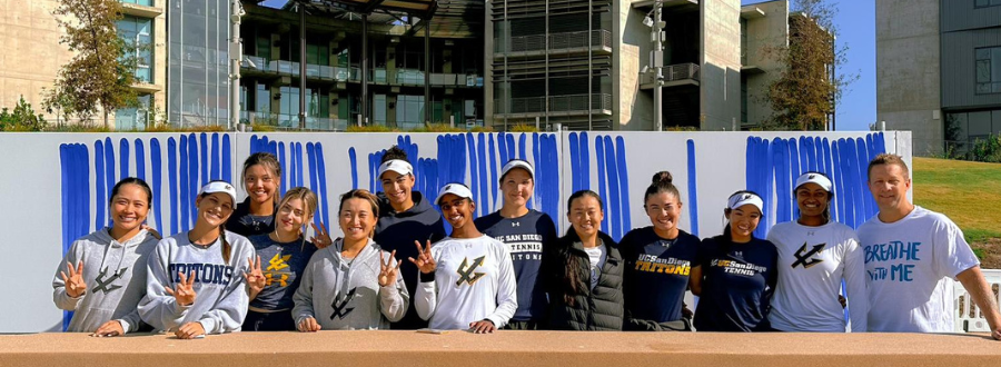 4 of 8, An athletics team poses with Jeppe Hein in front of a white canvas with blue lines